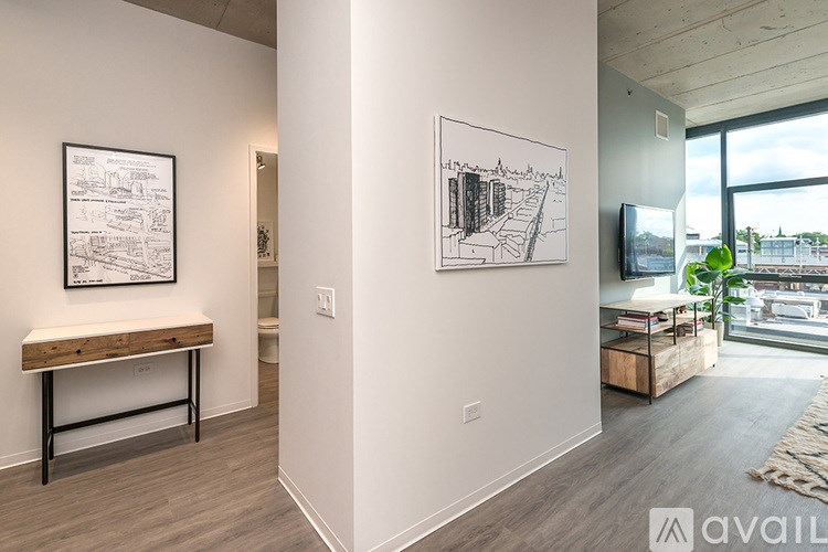 A room with a bench and two pictures on the wall.