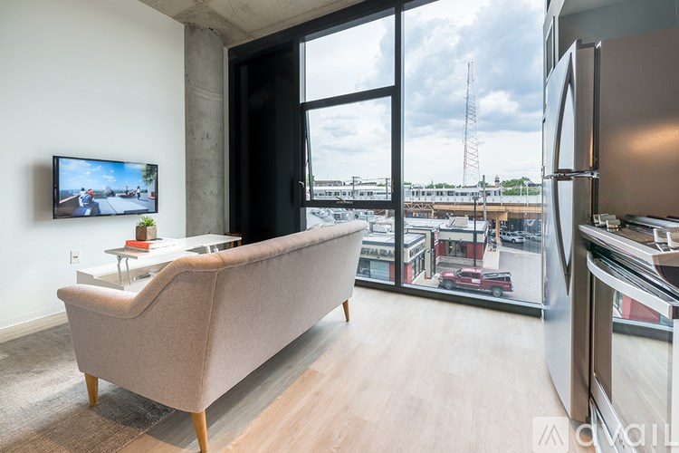 A modern living room with a large window overlooking a cityscape.
