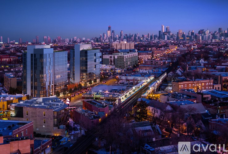A train is passing through a city with tall buildings.