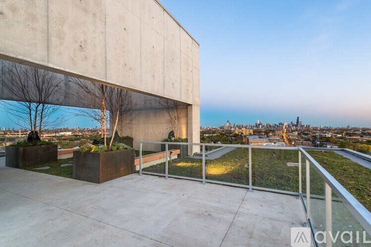 A concrete building with a balcony overlooking a city skyline.