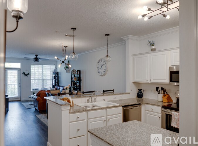 A kitchen with white cabinets and a large island.