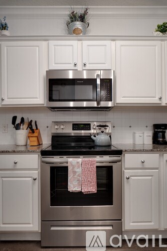 A kitchen with a stove top oven and a microwave above it.