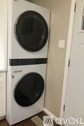 A white LG front loading washing machine in a small laundry room.
