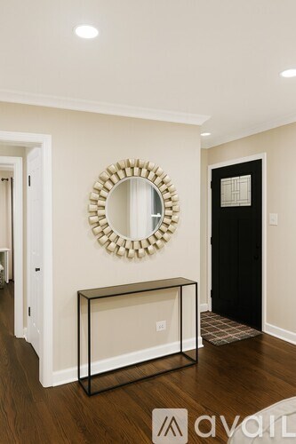 A mirror is on the wall above a console table.