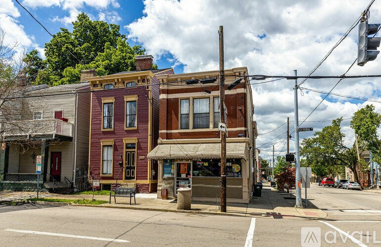 A street view of a row of old buildings with a clear sky above.