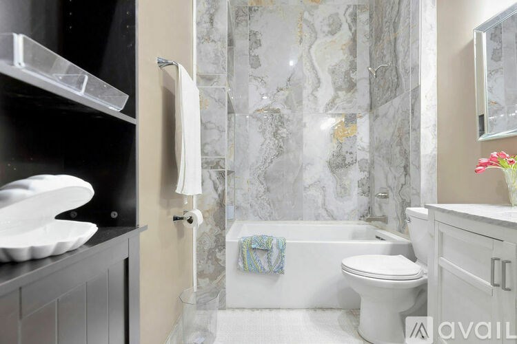 A bathroom with a marble wallpaper and a white toilet.