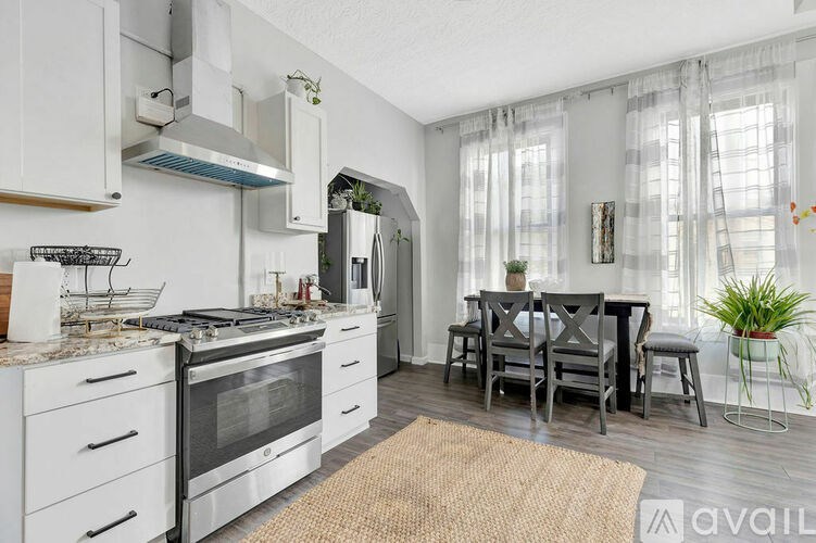 A modern kitchen with a dining table set up.