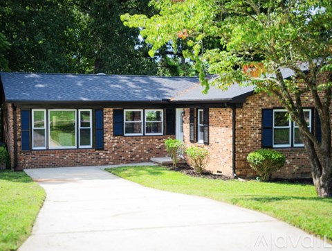 A house with a brick facade and a grey roof.