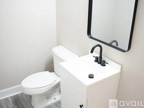 A white toilet sits next to a sink in a bathroom.