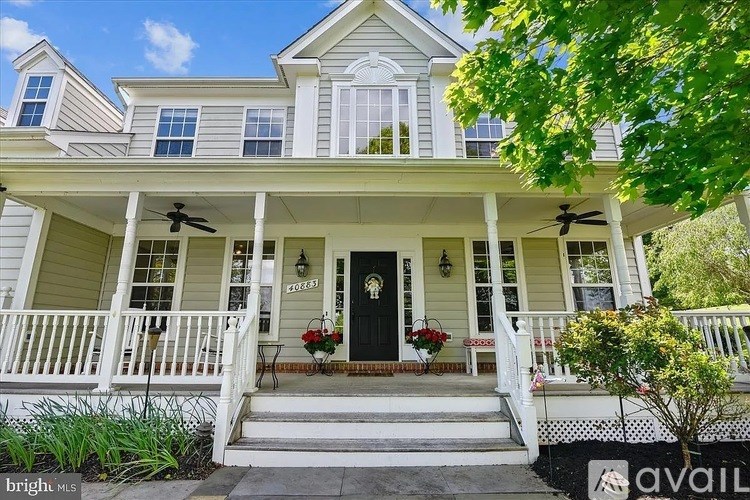 A house with a front porch and a black door.