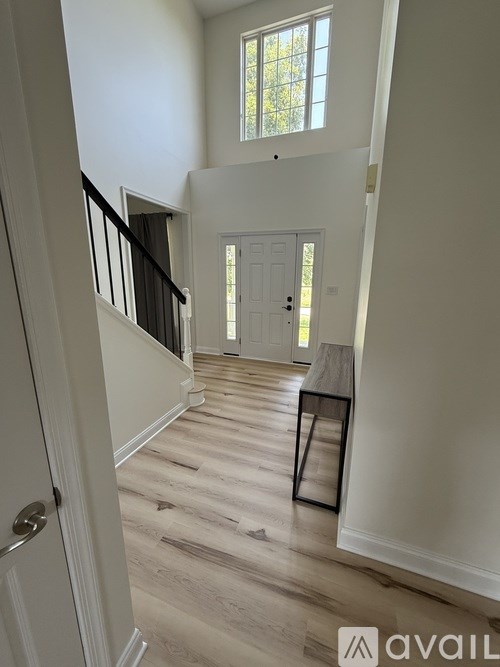 A hallway with a bench and a door.