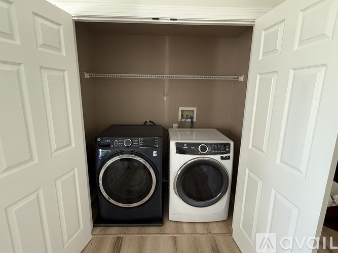 Two washing machines in a small laundry room.