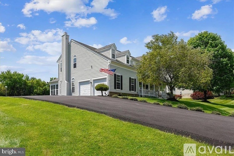 A house with a flag on the front is for sale.