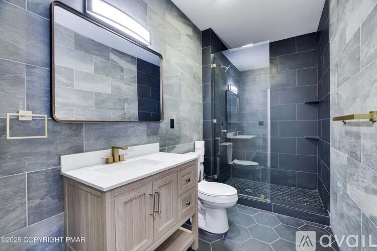 A bathroom with a sink, toilet, and shower.