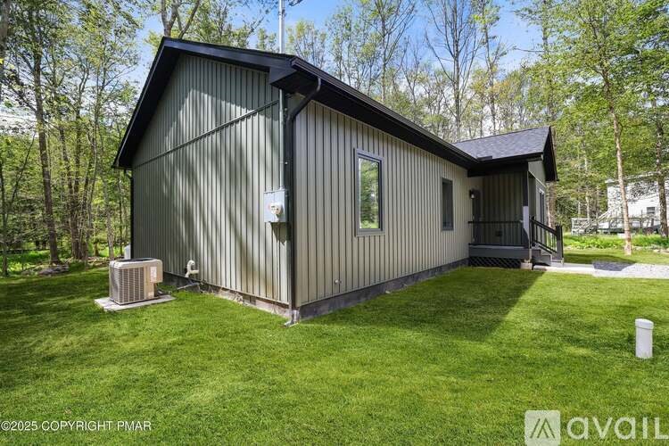 A small house with a green lawn in front.