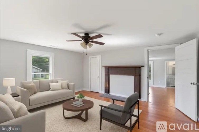 A living room with a couch, chair, and coffee table.