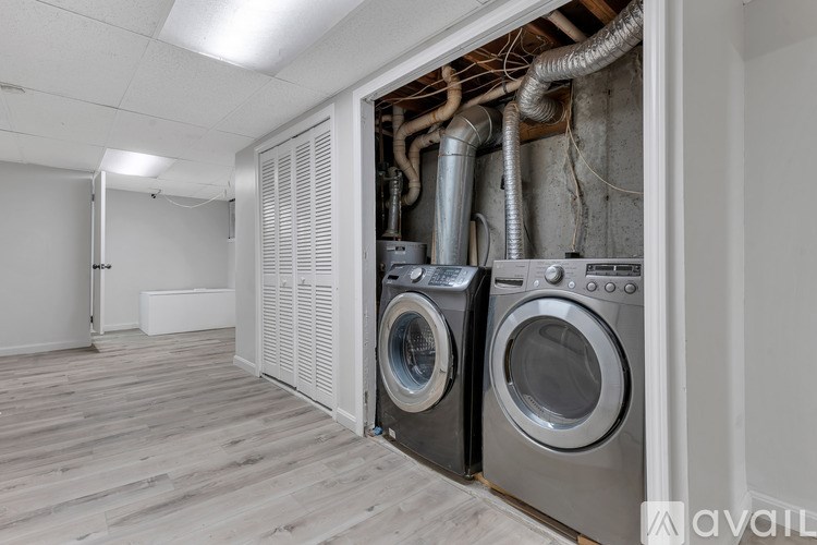 A wall-mounted dryer is tucked into a wall.