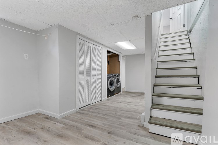 A room with a staircase leading to another floor.