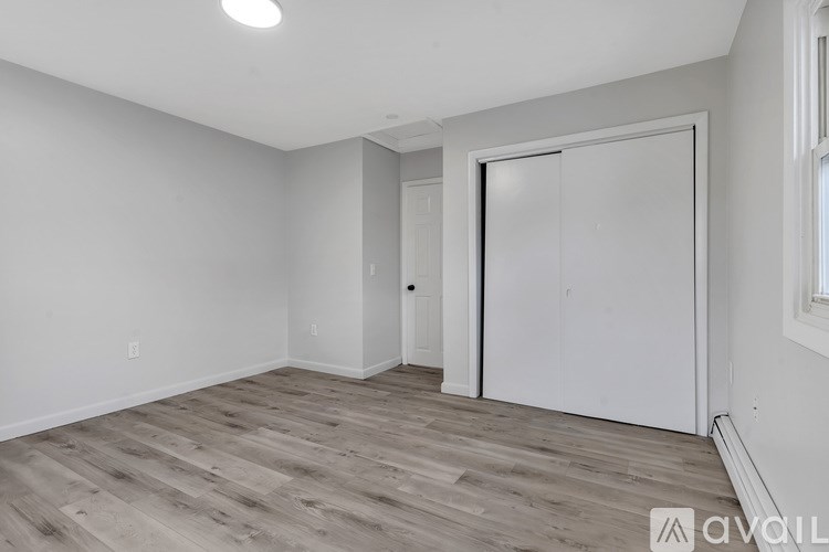 A room with a wooden floor and white walls.