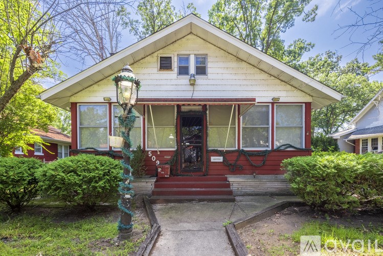 A house with a red front door and a white porch.