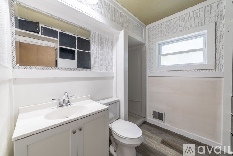 A bathroom with a white sink and toilet.