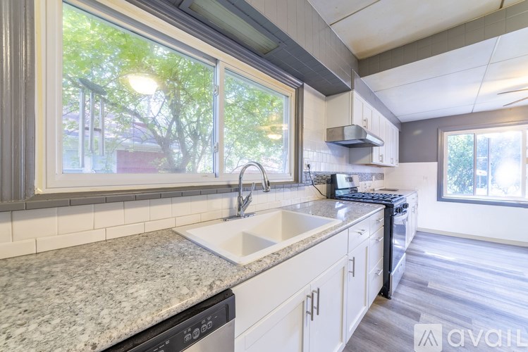 A kitchen with granite countertops and stainless steel appliances.