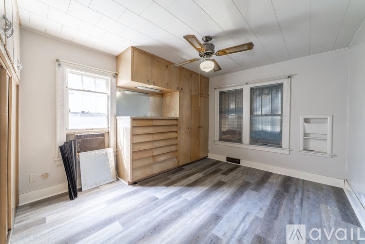 A room with wooden floors and a ceiling fan.