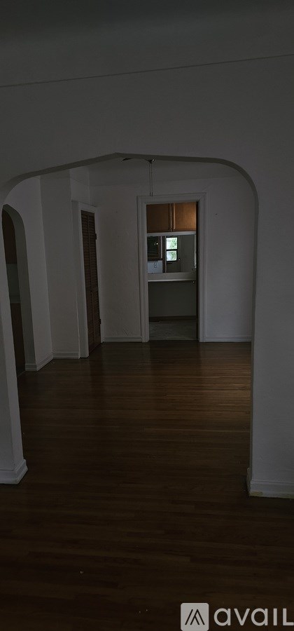 A room with wooden floors and white walls.