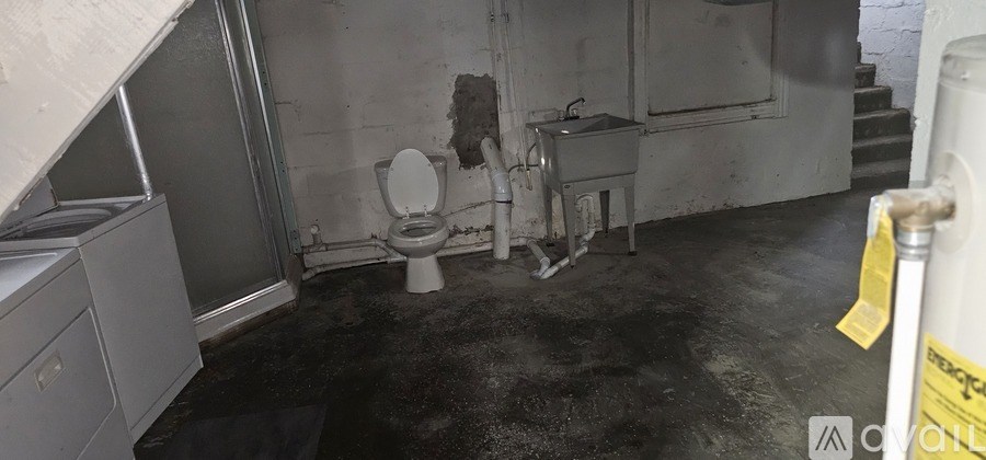 A dirty bathroom with a toilet and sink.