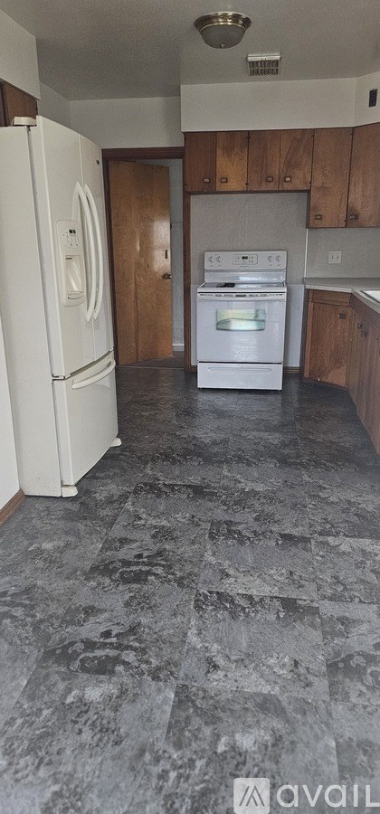 A kitchen with a white fridge and a white oven.