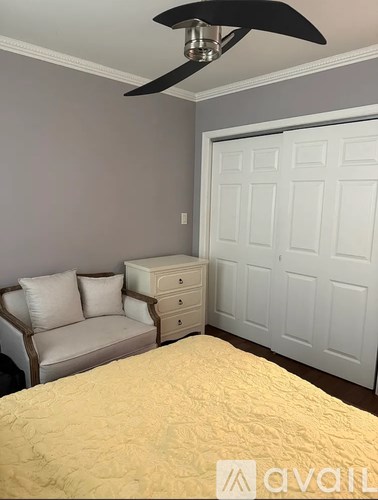 A bedroom with a bed, dresser, and chair.