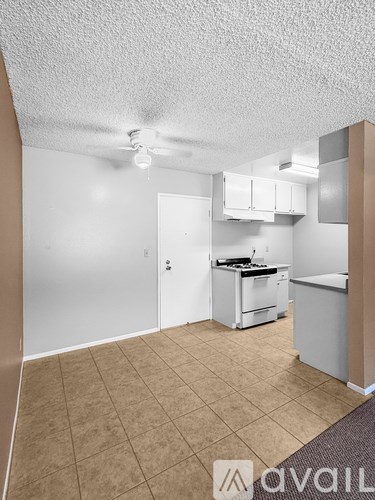 A kitchen area with a stove, oven, and cabinets.