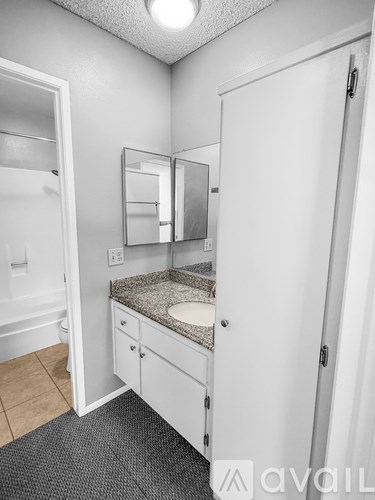 A bathroom with a sink, mirror, and medicine cabinet.