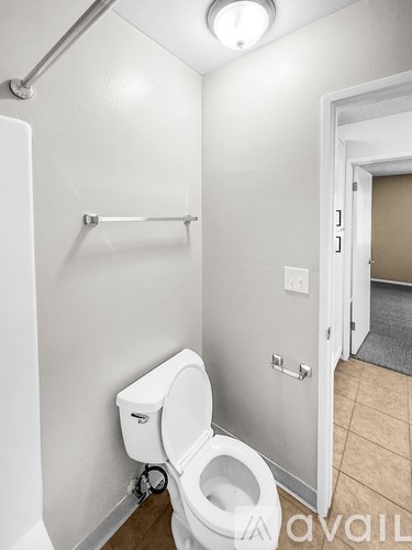 A white toilet in a small bathroom with a white door.