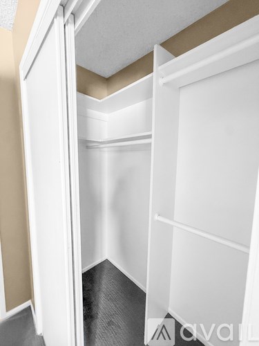 A white pantry with a white door open.