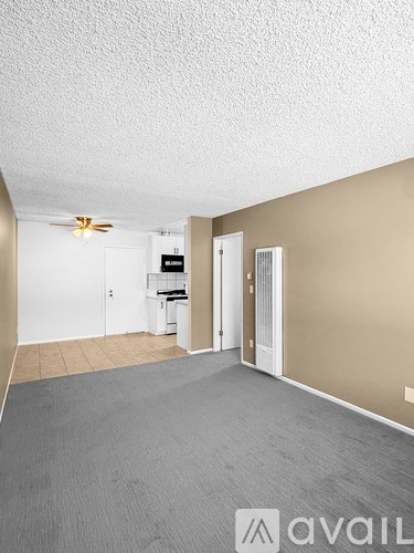 A room with a fan and a washing machine.