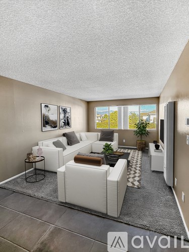 A living room with a white couch and a coffee table.