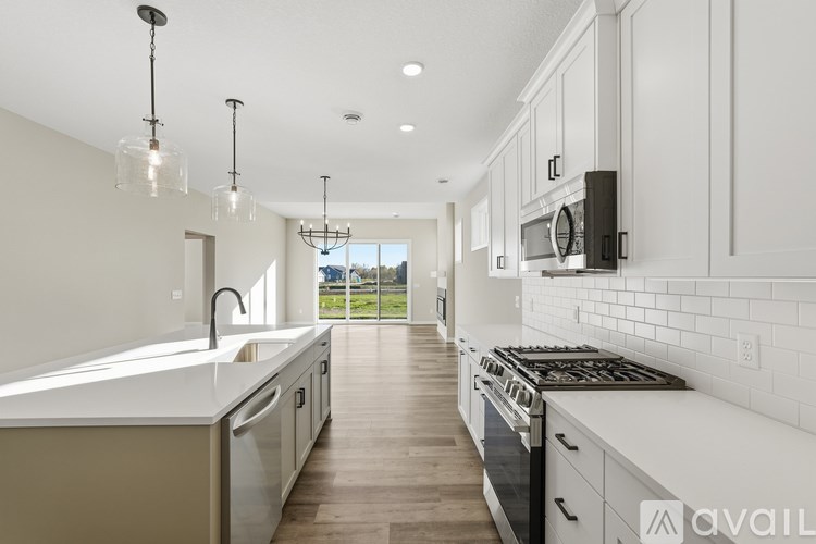 A modern kitchen with white cabinets and a large island.