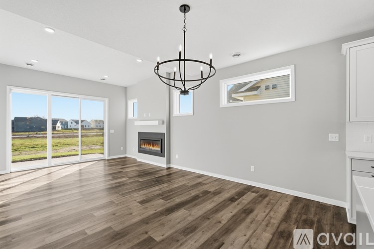 A modern living room with a fireplace and a chandelier.