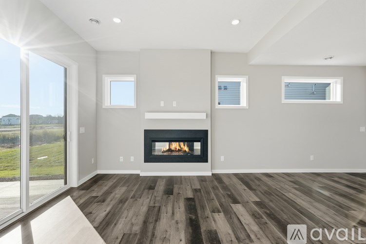 A modern living room with a fireplace and wooden floors.