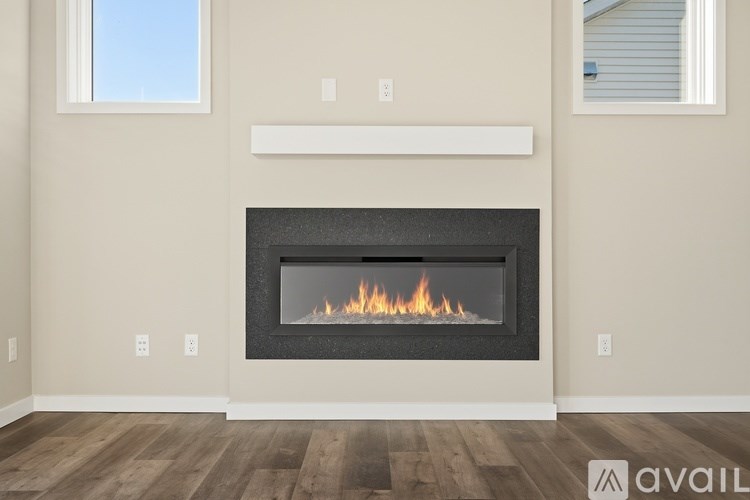 A modern fireplace with a fire burning inside.