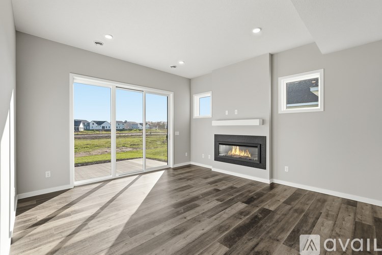 A modern living room with a fireplace and sliding glass doors.
