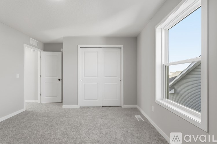 A room with two doors and a window.