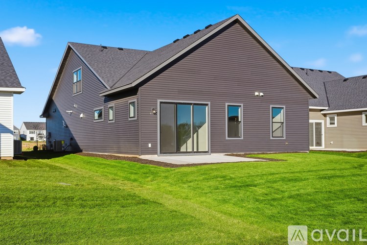 A house with a grey exterior and a large front yard.