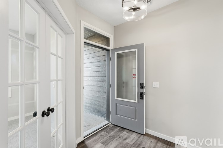 A modern interior with a white door and a grey door.