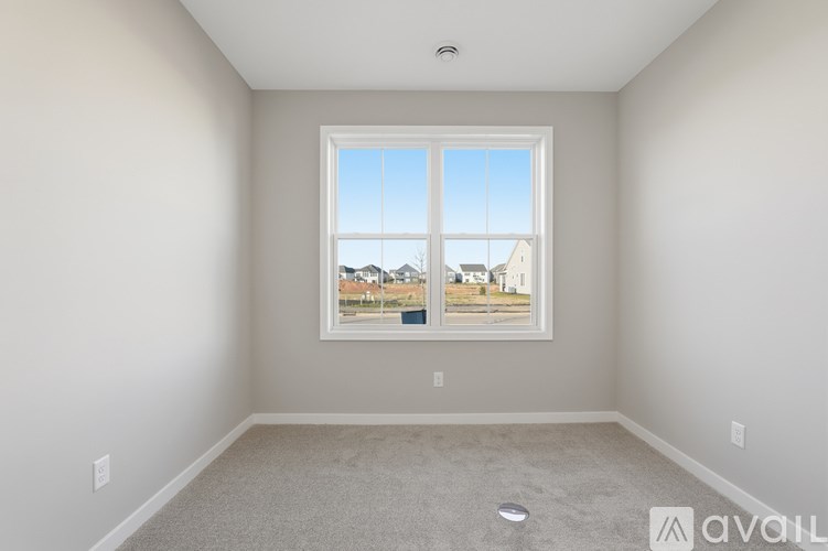 A room with a large window overlooking a street.