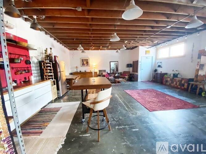 A room with a wooden ceiling and a table with chairs.