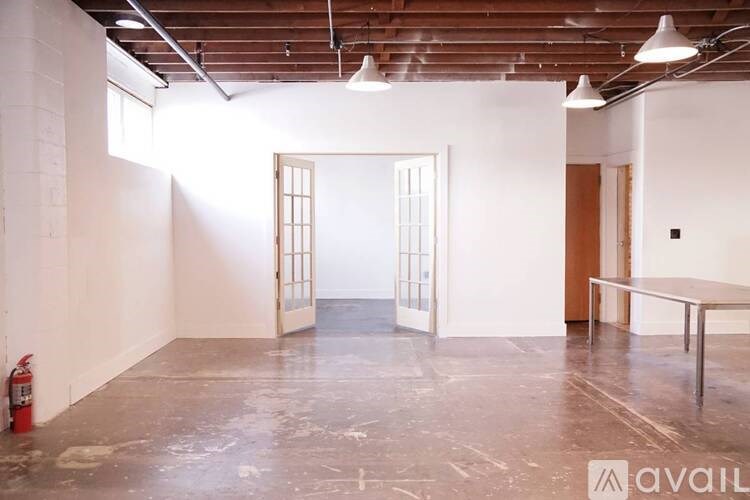 A room with a fire extinguisher on the floor.