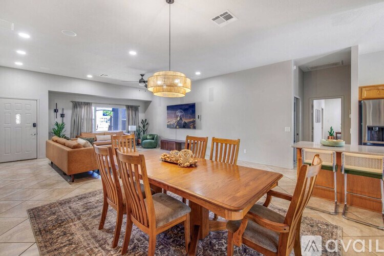 A dining room with a wooden table and chairs.