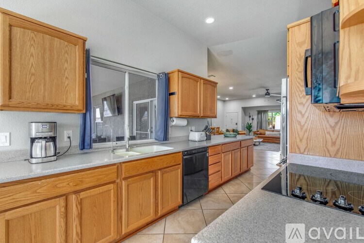 A kitchen with wooden cabinets and a granite countertop.